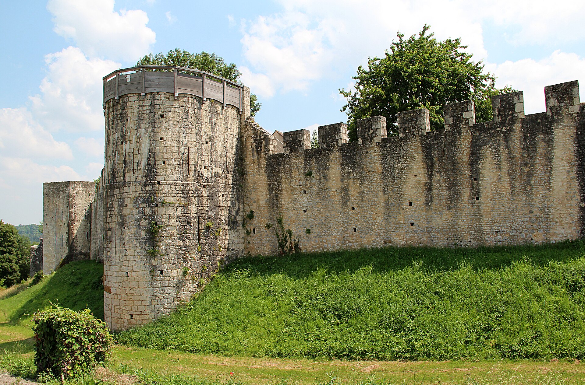 The medieval ramparts and towers of Provins under a summer sky