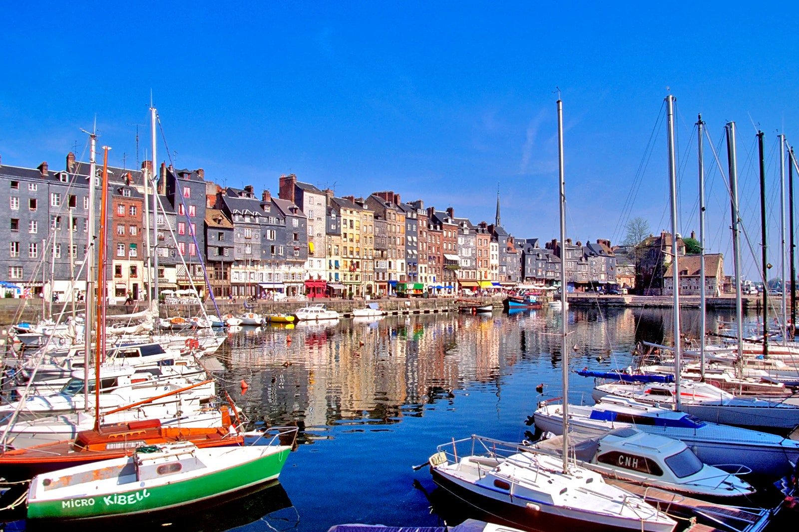 Sailing boats and colourful historic houses around the Vieux Bassin in Honfleur